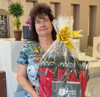 Prize winner holding gift basket.